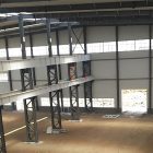What are the advantages of using steel structures in workshop building?
